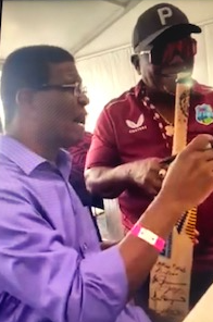 Hall of Famer Rowe signs bat for Hall of Famer Dr. Haynes